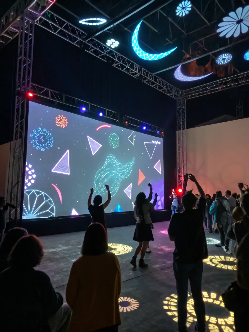 A picture of a multimedia art installation, featuring interactive elements and digital displays that encourage audience participation and exploration.