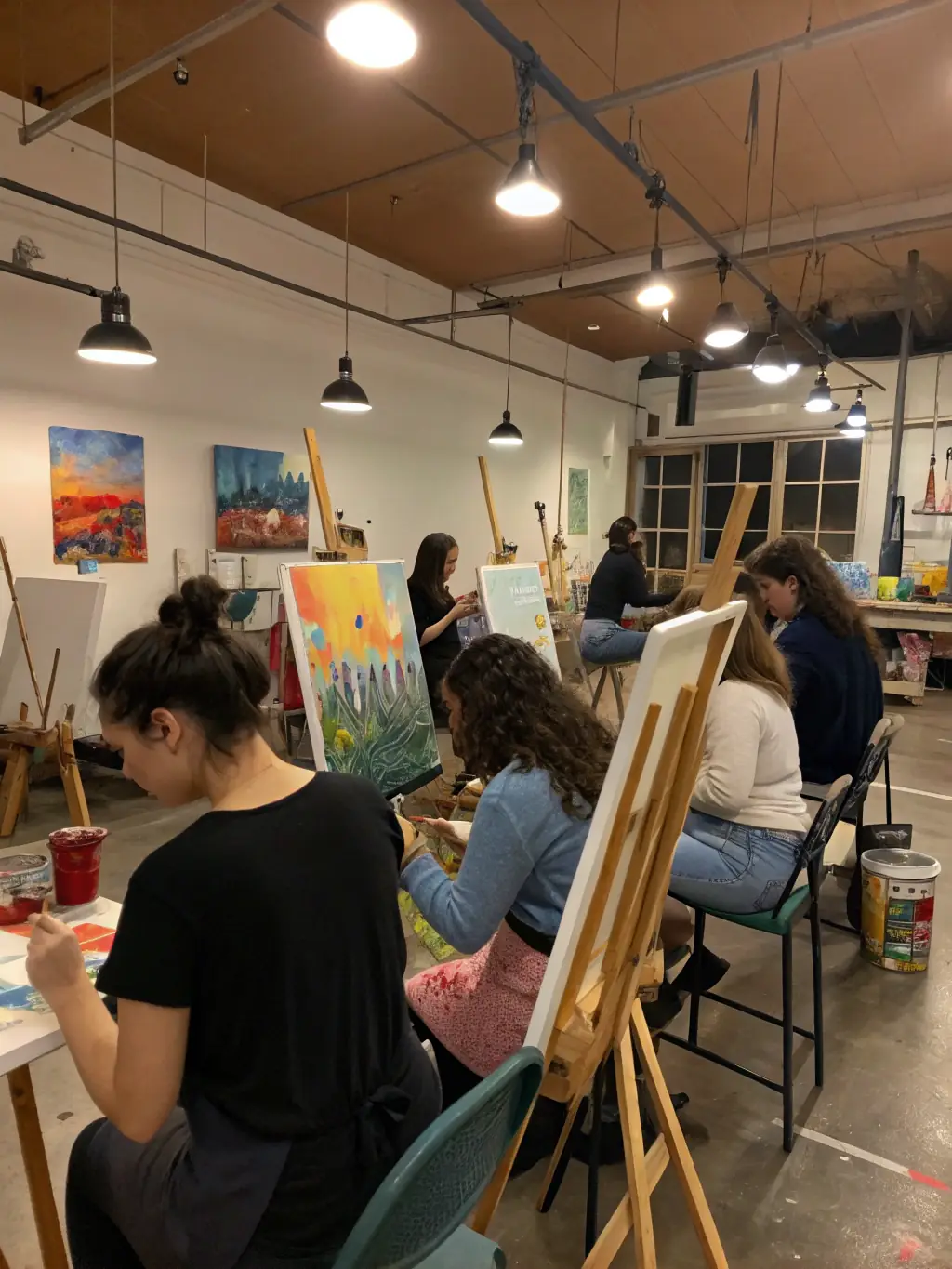 A vibrant photograph capturing a youth workshop session at PANTOUM, where participants are actively engaged in a collaborative art project, showcasing the organization's commitment to nurturing young talent and fostering creative expression.